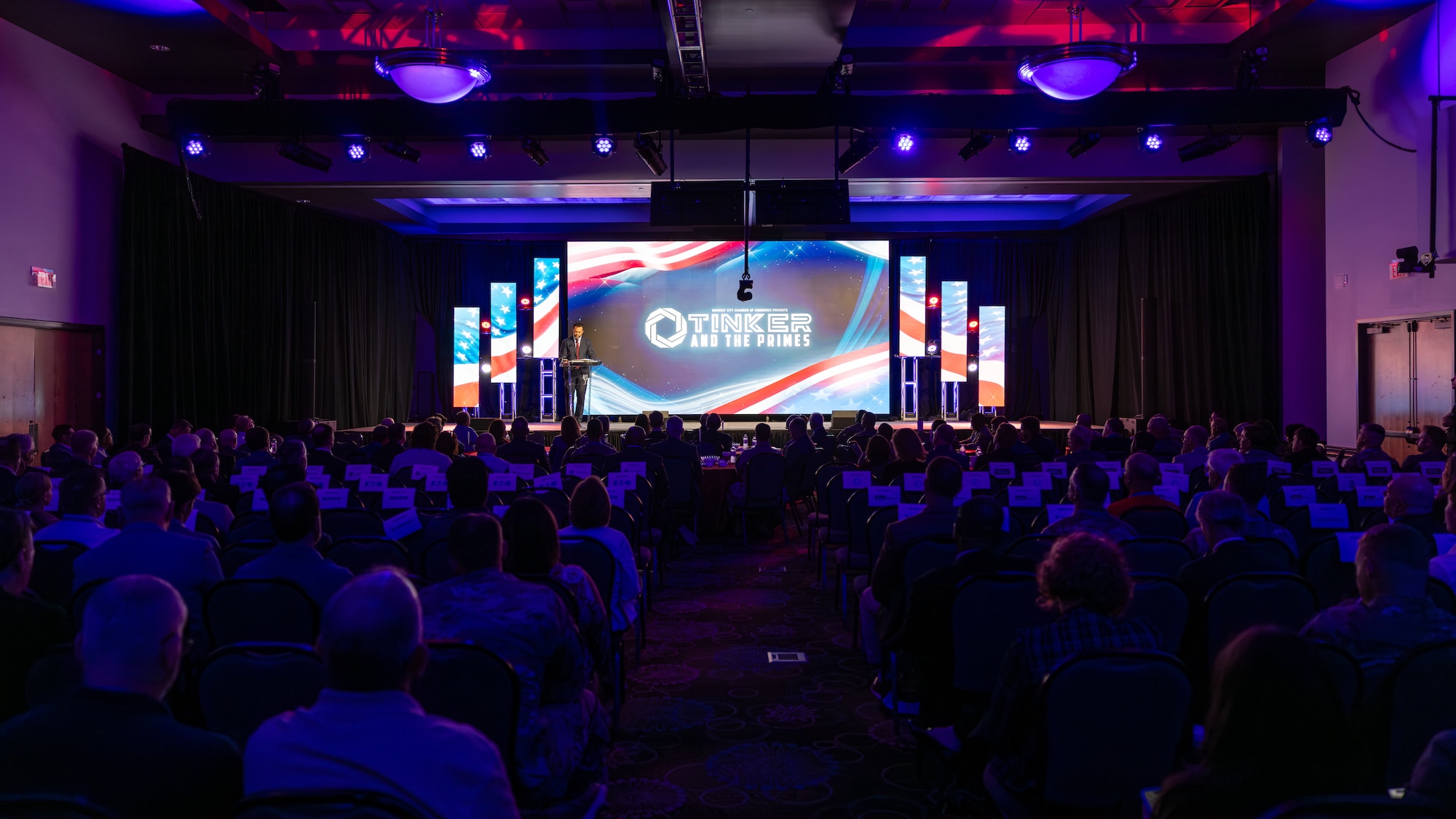 Audience watching man speaking on stage