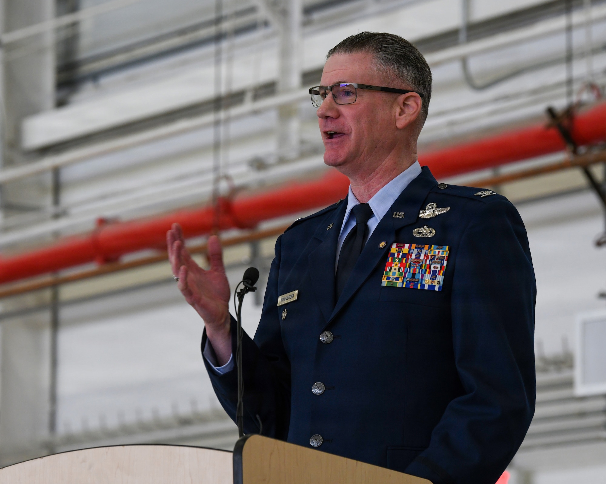 New York Air National Guard Col. Andrew J. Wineberger speaks during his retirement ceremony at Francis S. Gabreski Air National Guard Base in Westhampton Beach, N.Y., March 7, 2026. Wineberger, a command pilot with more than 4,300 flight hours, retired after 39 years of service with the 106th Rescue Wing. (U.S. Air National Guard photo by Tech. Sgt. Kevin Donaldson)