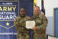 Army National Guard Sgt. 1st Class David Quinn, left, receives the Meritorious Service Medal