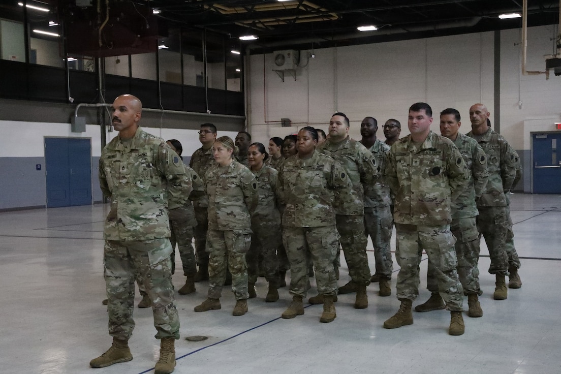 Illinois Army National Guard recruiters assigned to Foxtrot Company, Recruiting and Retention Battalion, Illinois Army National Guard, stand at parade rest during the retirement ceremony for Sgt. 1st Class David Quinn