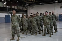 Illinois Army National Guard recruiters assigned to Foxtrot Company, Recruiting and Retention Battalion, Illinois Army National Guard, stand at parade rest during the retirement ceremony for Sgt. 1st Class David Quinn