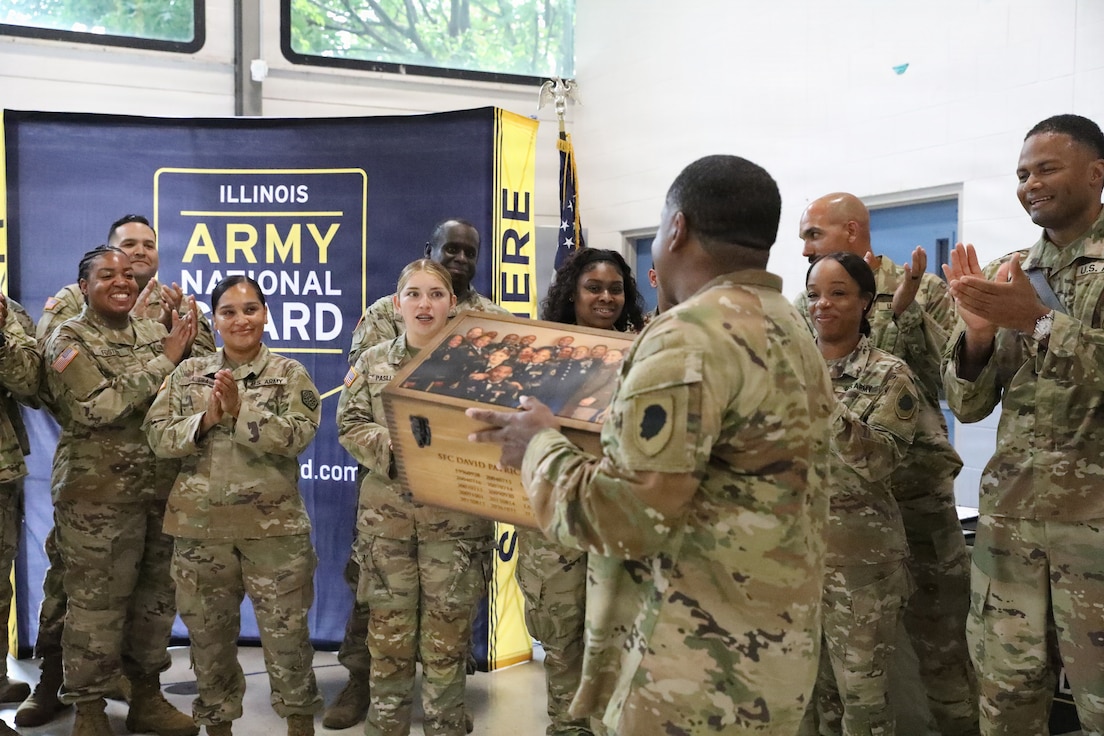 Illinois Army National Guard recruiters assigned to Foxtrot Company, Recruiting and Retention Battalion, Illinois Army National Guard, celebrate an outstanding career during the retirement ceremony for Sgt. 1st Class David Quinn