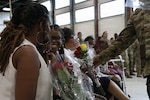 Family members of U.S. Army Sgt. 1st Class David Quinn accept flowers of appreciation during his retirement ceremony at the Crestwood Armory in Crestwood, Illinois, Aug. 10, 2026. The gesture acknowledged the sacrifices and vital support provided by the family during Quinn's service. (U.S. Army photo by Spc. Kristel Cordero, 139th Mobile Public Affairs Detachment, Illinois Army National Guard)