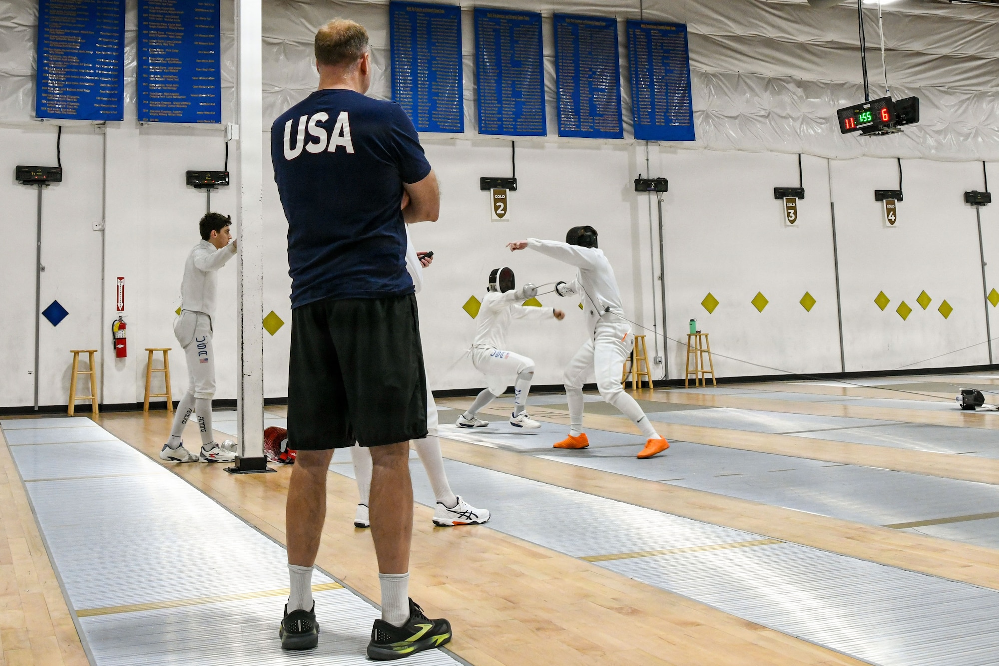members of a men's épée fencing team engage in a bout