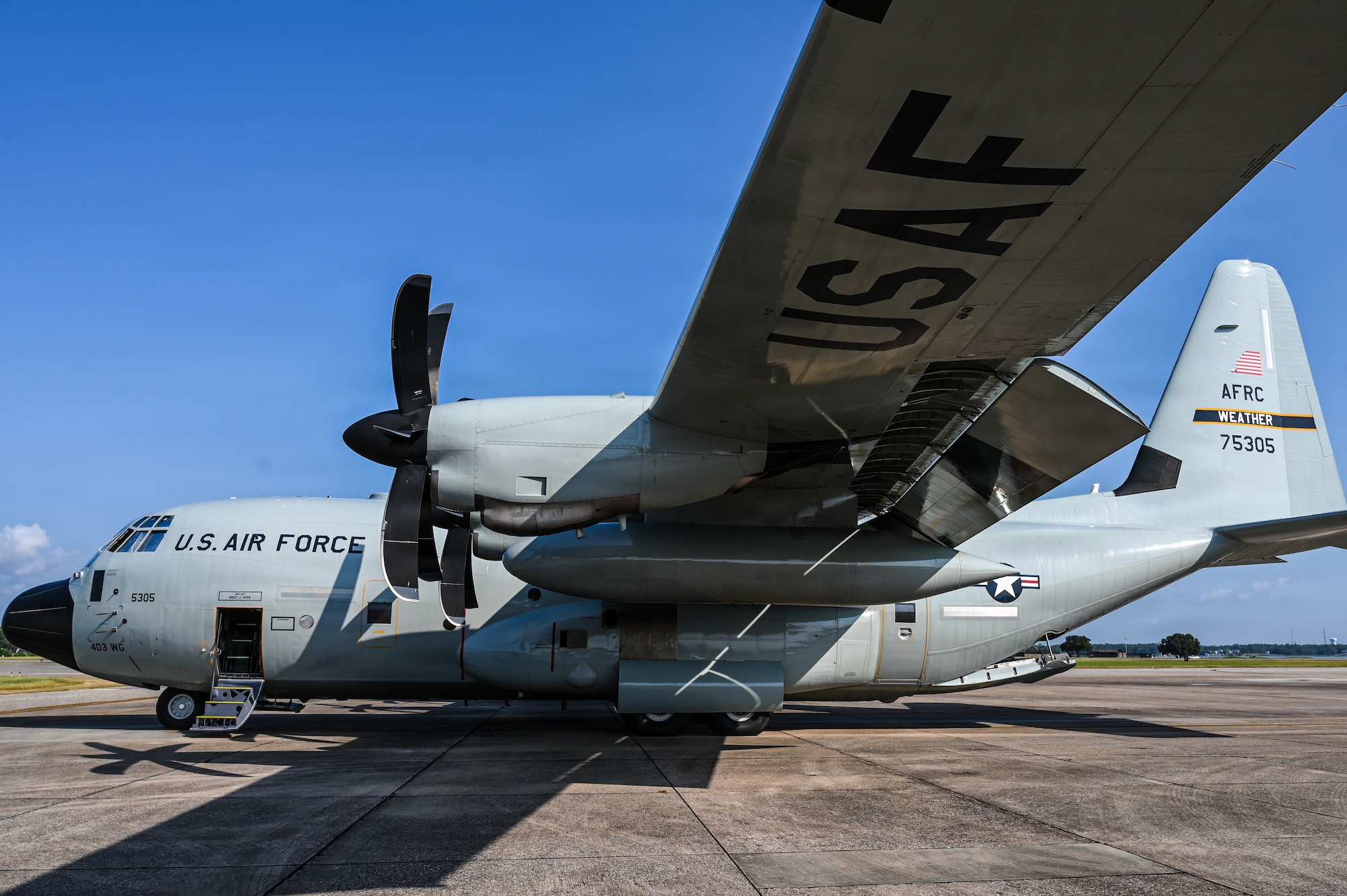 A WC-130J Super Hercules aircraft sits on the flight line