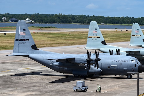 Three WC-130J Super Hercules aircraft wait on a flight line