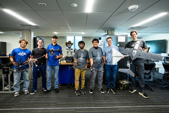 Hill's Black Knights team pose with a variety of drones they have built for base units. Operating out of the 309th Software Engineering Group's "Launch Pad," the team builds Blue-listed drones and provides flight training for its customers. (U.S. Air Force photo by R. Nial Bradshaw)