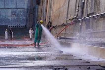 Dayton Remigio, Maintenance worker leader with Pearl Harbor Naval Shipyard and Intermediate Maintenance Facility (PHNSY & IMF), performs a high-pressure basin washdown of Dry Dock 2 immediately following dry dock dewatering at Joint Base Pearl Harbor-Hickam, July 7, 2026.