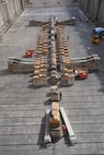 Workers perform a basin prepping of Dry Dock 2 immediately following dry dock dewatering at Pearl Harbor Naval Shipyard and Intermediate Maintenance Facility (PHNSY & IMF).