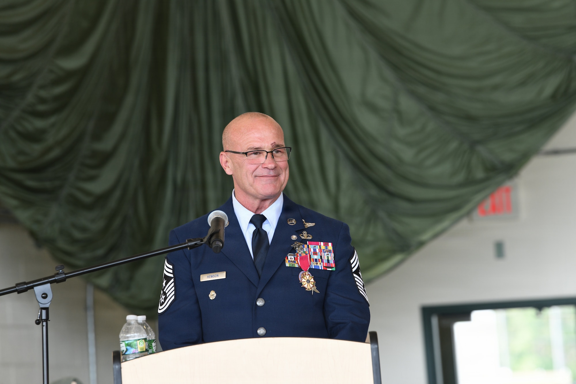 U.S. Air Force Command Chief Master Sgt. Michael T. Hewson, a Pararescueman and the New York Air National Guard's senior enlisted leader, speaks during his retirement ceremony at Francis S. Gabreski Air National Guard Base, Westhampton Beach, New York, Aug. 1, 2026. Hewson retired after 40 years of military service, including more than three decades with the 106th Rescue Wing. (U.S. Air National Guard photo by Tech. Sgt. Kevin Donaldson)