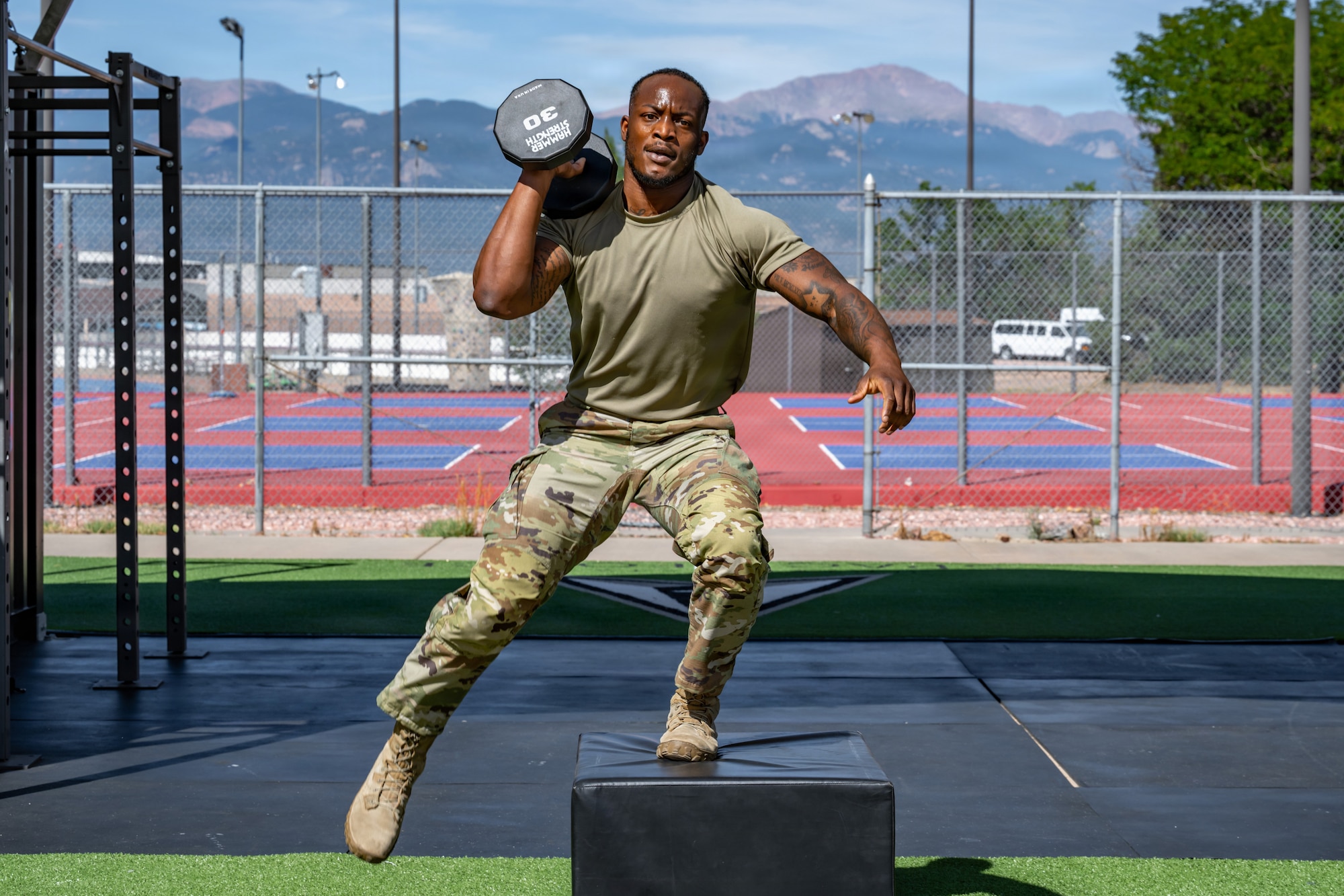 U.S. Air Force Airman 1st Class Jamari Broussard, 21st Security Forces Squadron response force member, performs a dumbbell box step-over