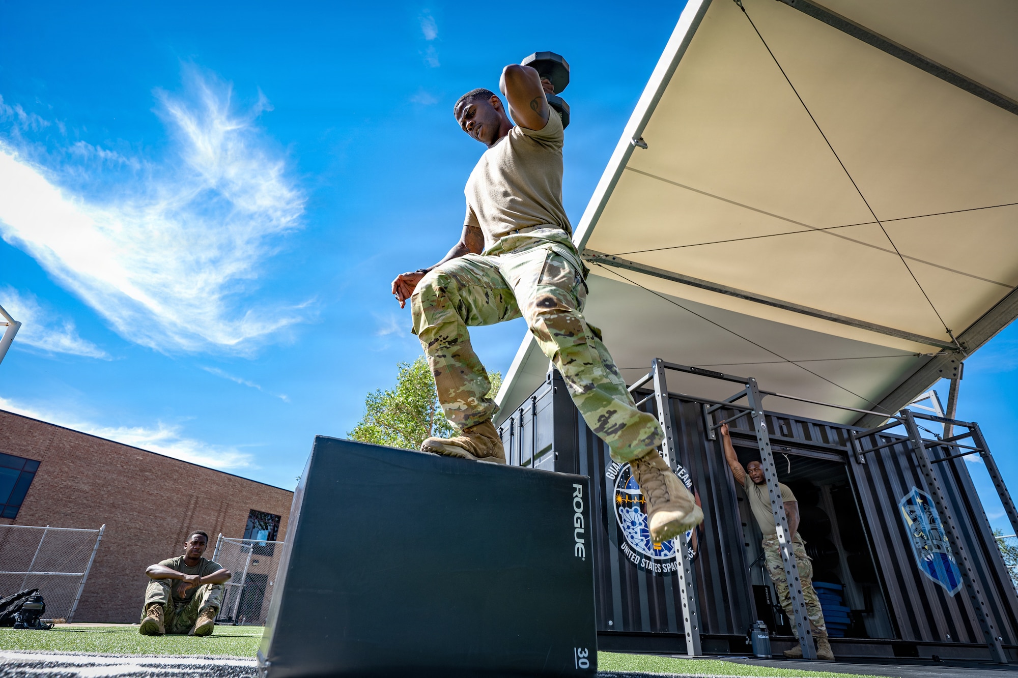 U.S. Air Force Master Sgt. Nicholas Brown, Space Base Delta 1 inspection manager, performs a dumbbell box step-over