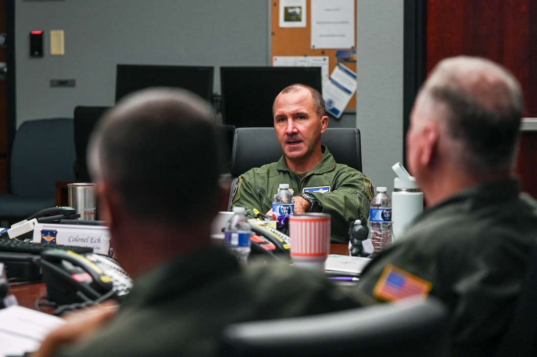 Men sit at a table talking