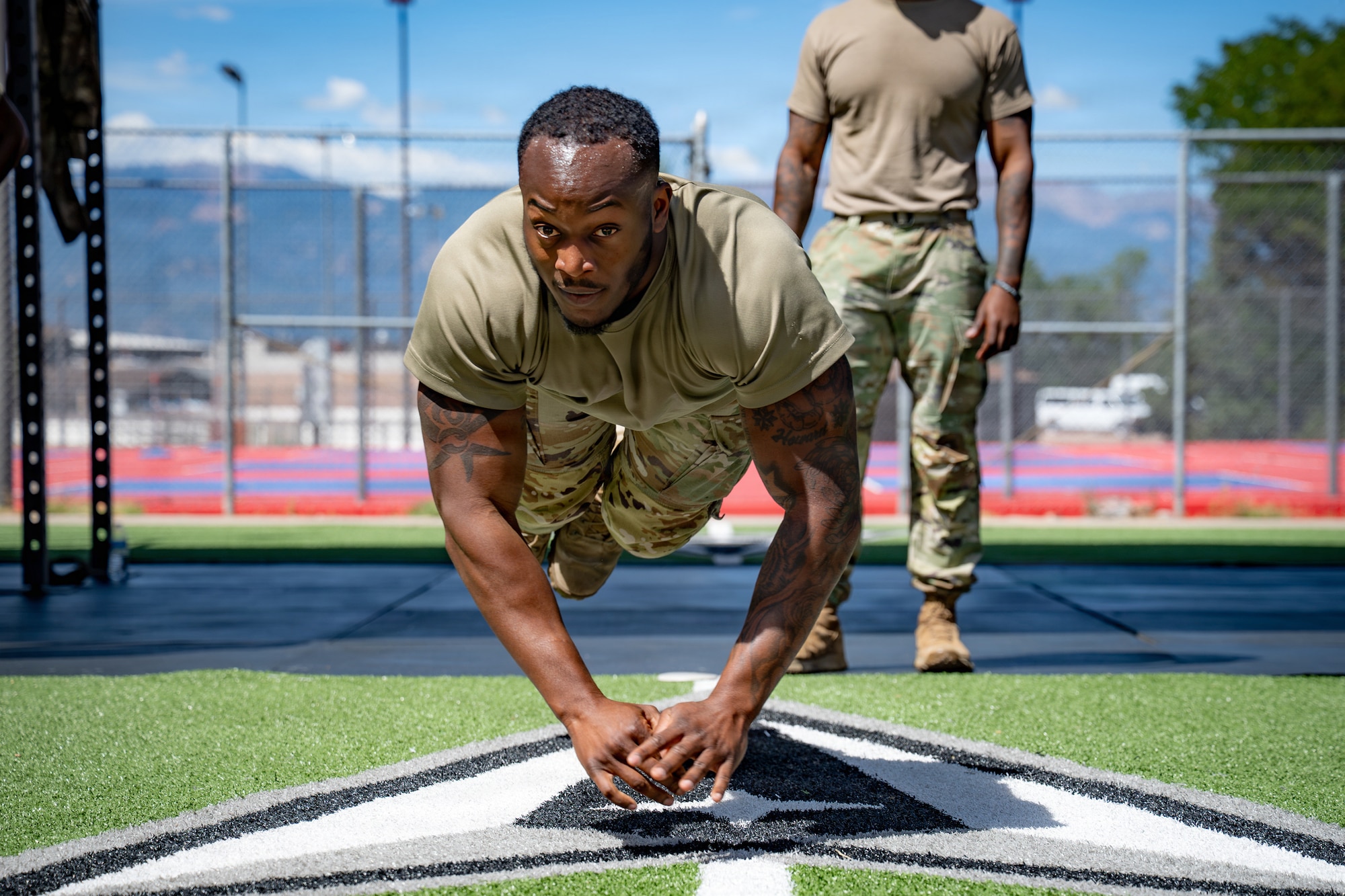 U.S. Air Force Airman 1st Class Jamari Broussard, 21st Security Forces Squadron response force member, performs a hand-release burpee