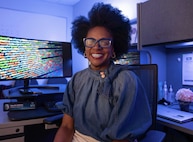 DAHLGREN, Va. – Myesha Dabney, a software safety engineer at NSWCDD, is at her workspace. Dabney is the recent recipient of the Navy Meritorious Civilian Service Award, recognizing her technical excellence and vital support to the software safety discipline. (Tierney Kunstmann/NSWCDD Photo)