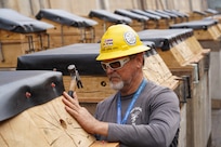 Michael Crabbe-Jones, wood/shipwrights specialist with  Pearl Harbor Naval Shipyard and Intermediate Maintenance Facility (PHNSY & IMF) finalizes the keel blocks in preparation for the docking of a Virginia-class fast-attack submarine at Joint Base Pearl Harbor-Hickam, July 7, 2026.