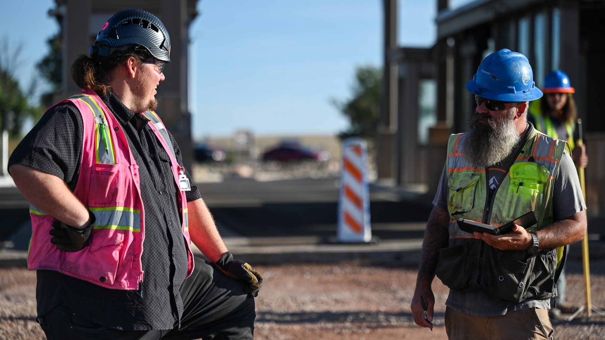 Two construction workers talk on Schriever Space Force Base, Colorado.