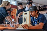 A Honolulu Community College summer academy student participates in a hands-on demonstration hosted by Pearl Harbor Naval Shipyard & Intermediate Maintenance Facility during a mini-trades fair at the Pacific Fleet Submarine Museum on July 15, 2026.