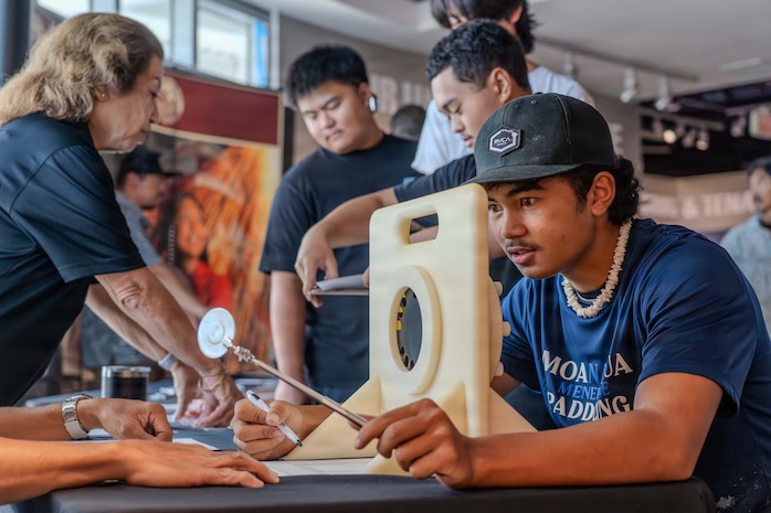 A Honolulu Community College summer academy student participates in a hands-on demonstration hosted by Pearl Harbor Naval Shipyard & Intermediate Maintenance Facility during a mini-trades fair at the Pacific Fleet Submarine Museum on July 15, 2026.