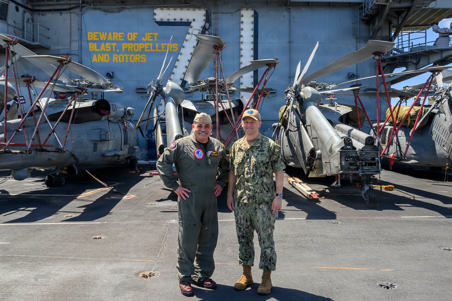 Rear Adm. Marcos Jasso, commander, Carrier Strike Group (CSG) 9, left, poses for a photo with Rear Adm. Chris Cavanaugh, commander, Submarine Force, U.S. Pacific Fleet, during the exercise Rim of the Pacific (RIMPAC), aboard Nimitz-class aircraft carrier USS Theodore Roosevelt (CVN 71), July 30, 2026. Thirty nations, over 30 surface ships, five submarines, 15 national land forces, more than 206 aircraft and 30,000 personnel are participating in RIMPAC in and around the Hawaiian Islands, June 24 to July 31. The world’s largest international maritime exercise, RIMPAC provides a unique training opportunity while fostering and sustaining cooperative relationships among participants critical to ensuring safety of sea lanes and security on the world’s oceans. RIMPAC 2026 is the 30th exercise in the series that began in 1971. (U.S. Navy photo by Mass Communication Specialist 2nd Class Ryan Holloway)
