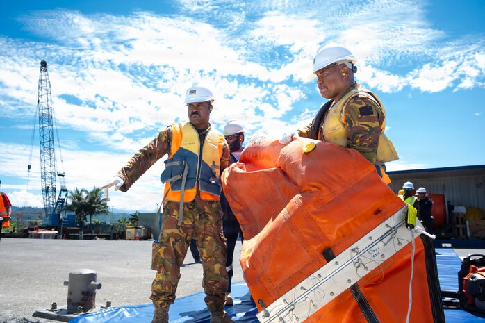Members of the  Papua New Guinea (PNG)  Defense Force, PNG National Disaster Centre, PNG Port of Lae, provincial disaster offices,  U.S. and international disaster response organizations, retrieve an inflatable oil containment boom during the Center for Excellence in Disaster Management and Humanitarian Assistance (CFE-DMHA) Field Training Exercise, Aug. 13, 2026,