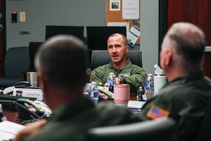 Men sit at a table talking