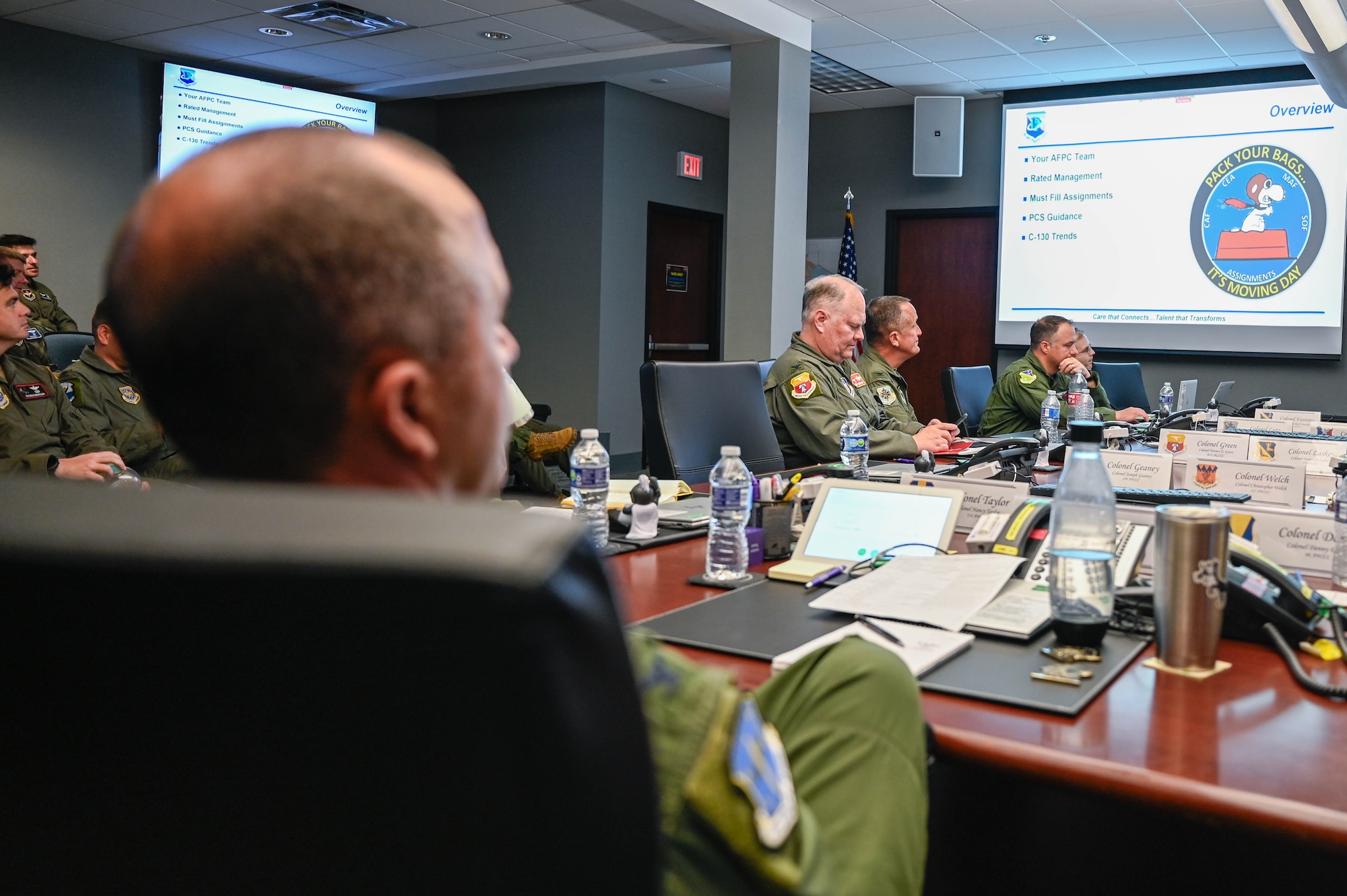 Men sit at a table during a meeting.