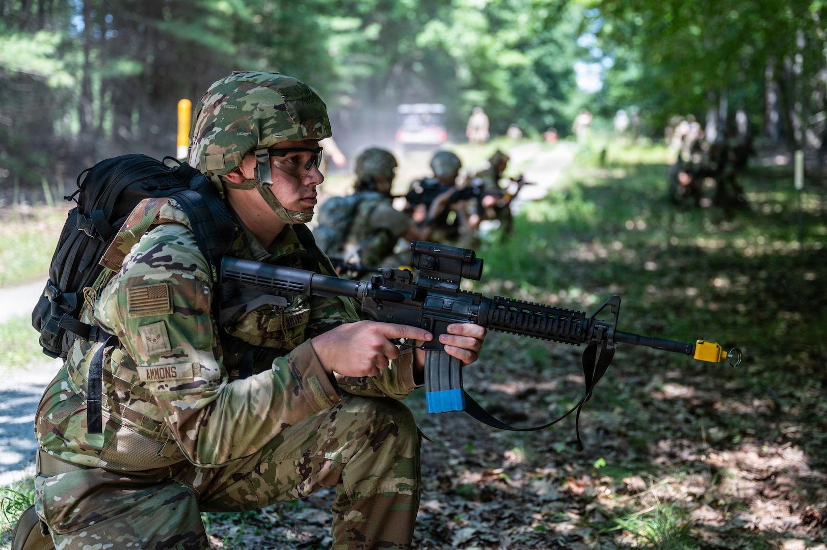Airmen establish a defensive perimeter in the forest.