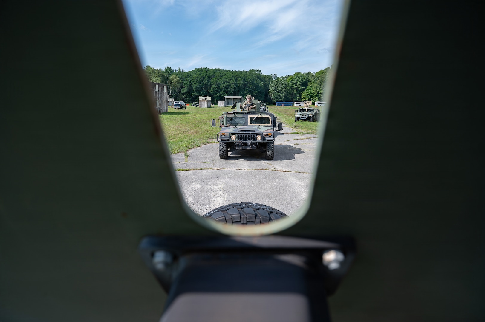 A U.S. Air National Guard tactical vehicle travels along a wooded route during convoy training at Patriot Forge II.