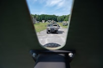 A U.S. Air National Guard tactical vehicle travels along a wooded route during convoy training at Patriot Forge II.