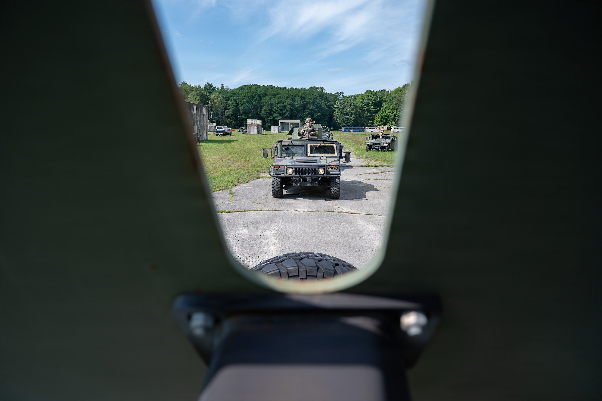 A U.S. Air National Guard tactical vehicle travels along a wooded route during convoy training at Patriot Forge II.