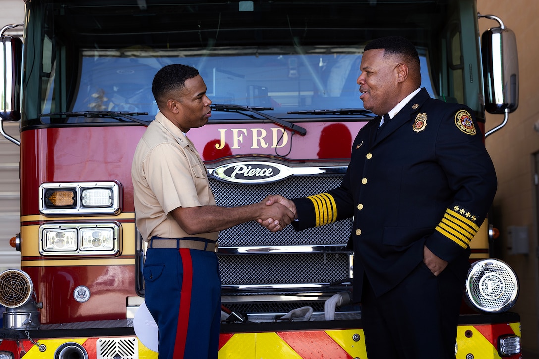 U.S. Marine Corps Col. David Merles, commanding officer of Marine Corps Support Facility Blount Island, shakes hands with Fire Chief Percy Golden II, director of the Jacksonville Fire and Rescue Department, following the Fire Station 48 opening ceremony Aug. 19, 2026, on Blount Island in Jacksonville, Florida. The new station, located immediately outside the installation’s main gate, strengthens emergency response for the Marine facility, port operations and nearby communities. (U.S. Marine Corps photo by Dustin Senger)