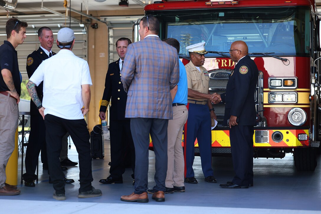 U.S. Marine Corps Col. David Merles, commanding officer of Marine Corps Support Facility Blount Island, greets Percy Golden Sr., a critical incident officer with the Jacksonville Fire and Rescue Department, following the Fire Station 48 opening ceremony Aug. 19, 2026, on Blount Island in Jacksonville, Florida. Golden served as chaplain during the ceremony. The new station, located immediately outside the installation’s main gate, improves emergency response for the Marine facility, port operations and nearby communities. (U.S. Marine Corps photo by Dustin Senger)
