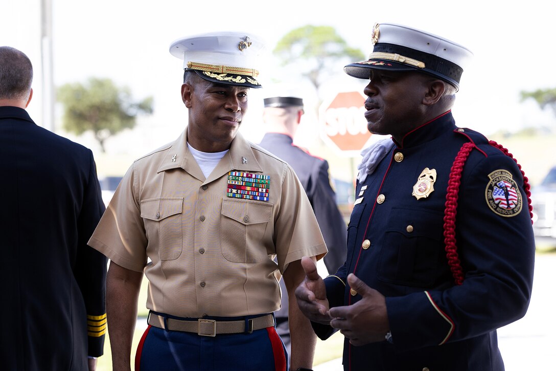 U.S. Marine Corps Col. David Merles, commanding officer of Marine Corps Support Facility Blount Island, speaks with Jacksonville Fire and Rescue Department Lt. L.G. Washington during the Fire Station 48 opening ceremony Aug. 19, 2026, on Blount Island in Jacksonville, Florida. Washington, a member of the ceremony’s honor guard, retired from the U.S. Navy as a chief petty officer after 24 years of service, with Naval Air Station Jacksonville as his final duty station. (U.S. Marine Corps photo by Dustin Senger)