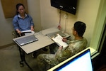 A U.S. Soldier takes notes while speaking to an Airman with the U.S. Air Force Language Enabled Airman Program in a foreign language during a simulated interrogation at Joint Base San Antonio-Camp Bullis, Texas, Feb. 26, 2026. The Airman played the role of a foreign civilian holding critical information, testing the Soldier’s translation and interview skills during exercise Cobra Engaged, hosted by Camp Bullis Foundry. (U.S. Air Force photo by Kathryn R.C. Reaves)