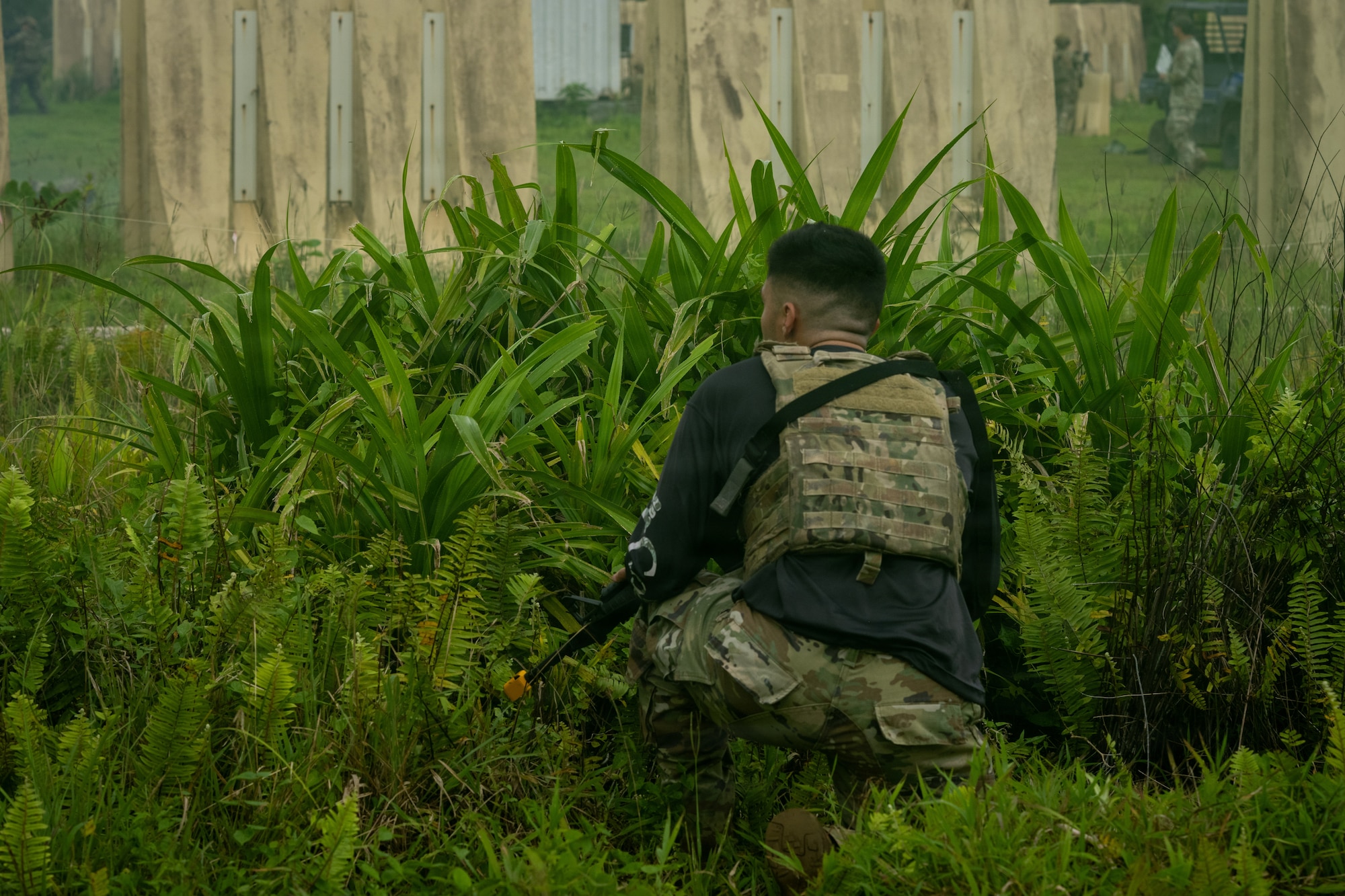 U.S. Air Force Senior Airman Regino Deanda, 21st Combat Air Base Squadron response force leader, infiltrates a simulated compound as an opposing forces member during Pacific Defender Sustainment Training 2026 at Northwest Field, Guam, August 7, 2026. By providing personnel to serve as both response and opposing forces, the 21st CABS helped create realistic and dynamic training scenarios that tested participants’ readiness and decision-making during PDST. (U.S. Air Force photo by Senior Airman Adrien Tran)