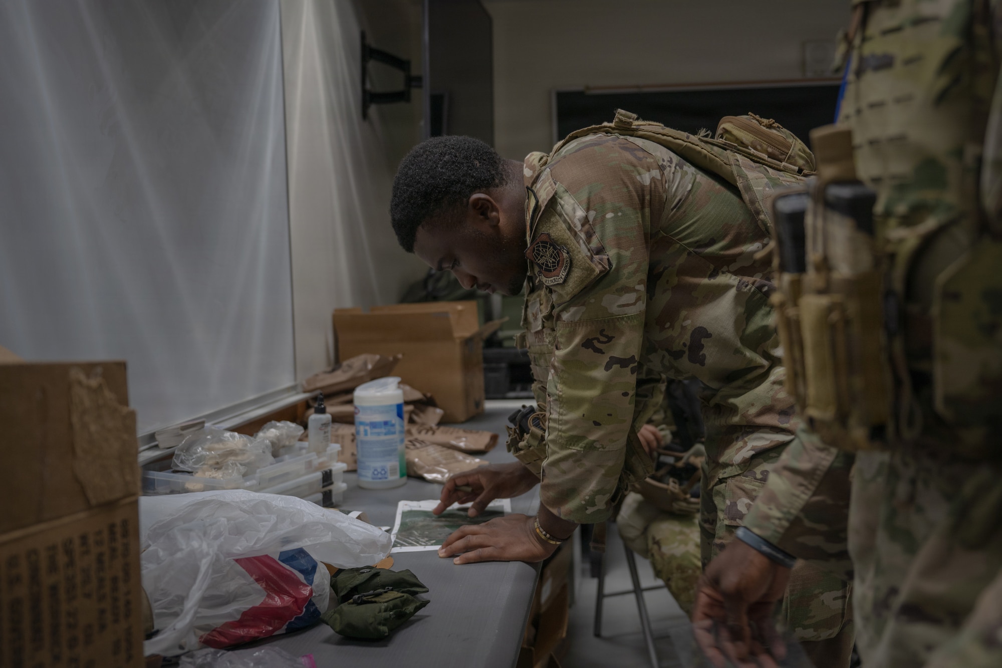 U.S. Air Force Senior Airman Elijah Pogue, 21st Combat Air Base Squadron defender, studies route plans during Pacific Defender Sustainment Training 2026 at Northwest Field, Guam, August 5, 2026. PDST is a recurring military exercise held at Andersen Air Force Base, Guam, to sharpen tactical proficiency and enhance airfield defense capabilities in the Pacific. (U.S. Air Force photo by Senior Airman Adrien Tran)