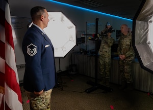 U.S. Air Force Senior Airman Jarrett Smith, 47th Flying Training Wing (FTW) public affairs journeyman, shows Col. Eric Bissonette, 47th FTW commander, how to operate the studio camera to take an official Air Force portrait of Master Sgt. Jordan Arredondo, 47th Security Forces Squadron silver flag Mission Qualification Course section chief, during Airman’s Time at Laughlin Air Force Base, Texas, Aug. 18, 2026. Studio photography is taught to Public Affairs Airmen during technical training, equipping them with the skills to produce professional imagery used to document Airmen, leaders and Air Force operations. (U.S. Air Force photo by Senior Airman Harrison Sullivan)