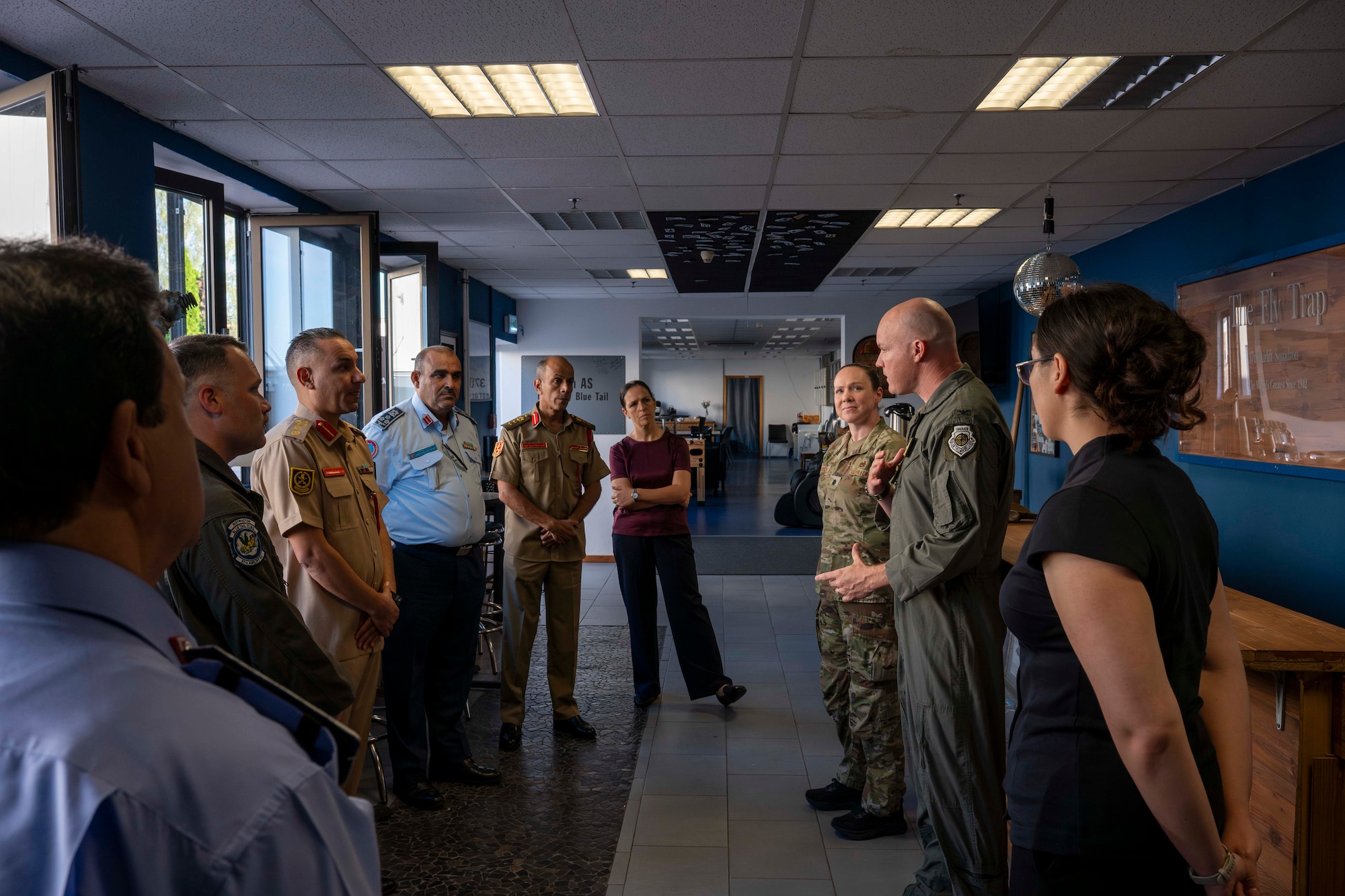 a group of people standing in a meeting