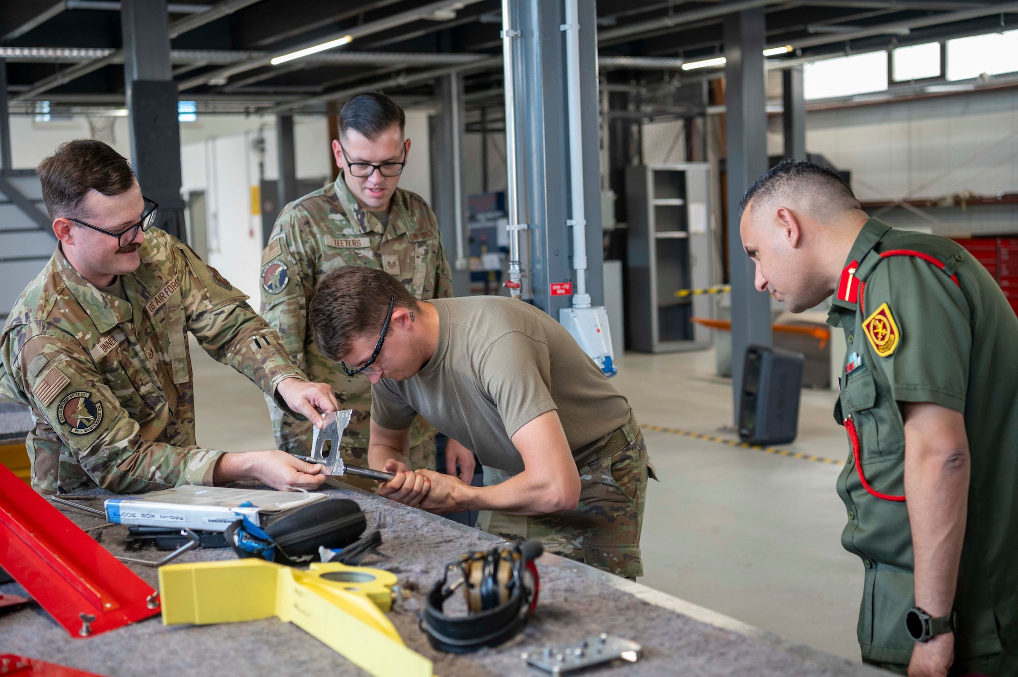 Four men doing mechanical work