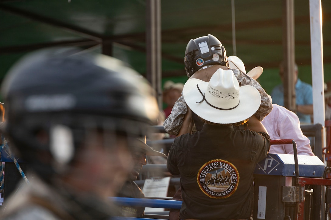 The U.S. Marine Corps Mounted Color Guard assists with the mutton busting event during the Big Sky Pro Rodeo at Great Falls, Montana, July 31, 2026. As the Marine Corps last remaining mounted color guard, the team continues a unique tradition of representing the Marine Corps through horsemanship at events such as the Big Sky Pro Rodeo. (U.S. Marine Corps photo by Sgt. Davin Tenbusch)
