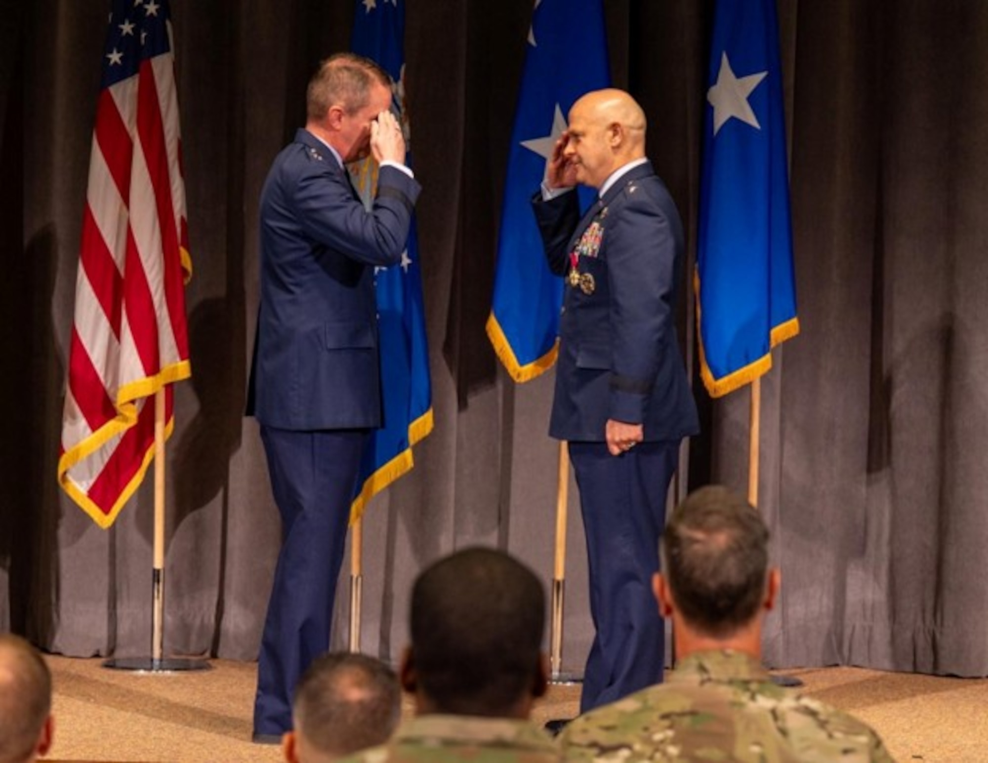 U.S. Air Force Brig. Gen. Joseph Sheffield, Jeanne M. Holm Center outgoing commander, salutes Maj. Gen. Jeffrey W. Nelson, Air Force Accessions Center commander, after receiving the Legion of Merit at Officer Training School, Maxwell Air Force Base, Aug 18, 2026. This change of command marks the transition of leadership for an organization responsible for Officer Training School, Air Force ROTC, Warrant Officer Training School, and Air Force Junior ROTC. (U.S. Air Force photo by Senior Airman Tanner Doerr)