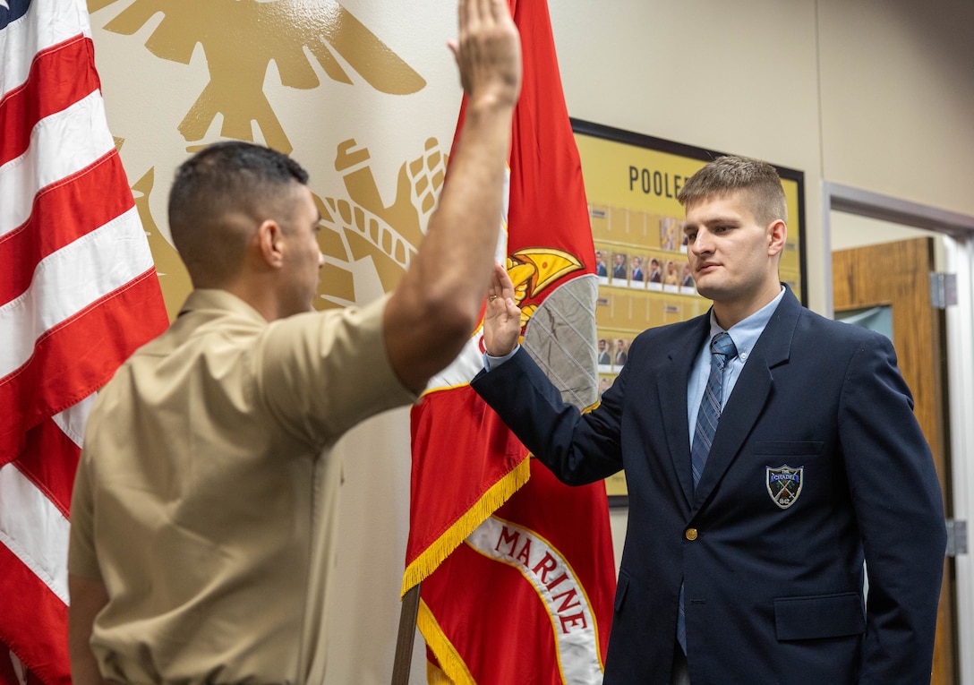 U.S. Marine Corps Capt. Adam Padilla, officer selection officer for Officer Selection Station Houston, Recruiting Station South Texas,  administers the Oath of Office to officer candidate Thomas Gehrke in Houston, Texas, July 9, 2026. Gehrke took the oath after earning his selection to attend Officer Candidates School, marking the first step toward earning a commission as a United States Marine Corps officer. (U.S. Marine Corps photo by Cpl. Christian Salazar)