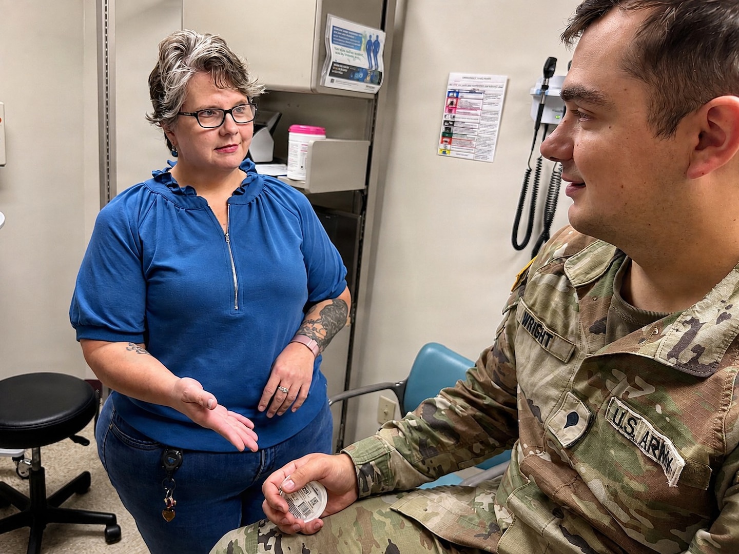 A hospital technician meets with a patient to discuss tobacco cessation in a clinical setting.