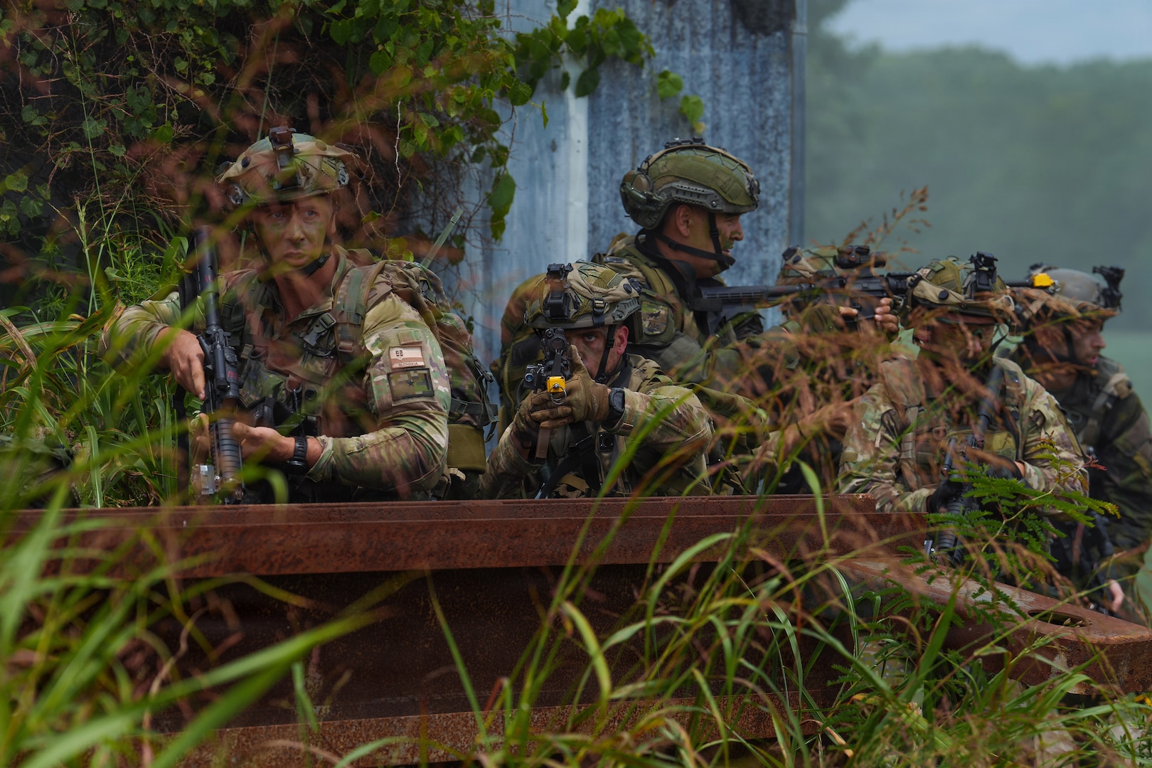 Slovak Armed Forces soldiers maneuver around a wall during an assault at a Combat Readiness Exercise at Muscatatuck Training Center near Butlerville, Ind., July 27.