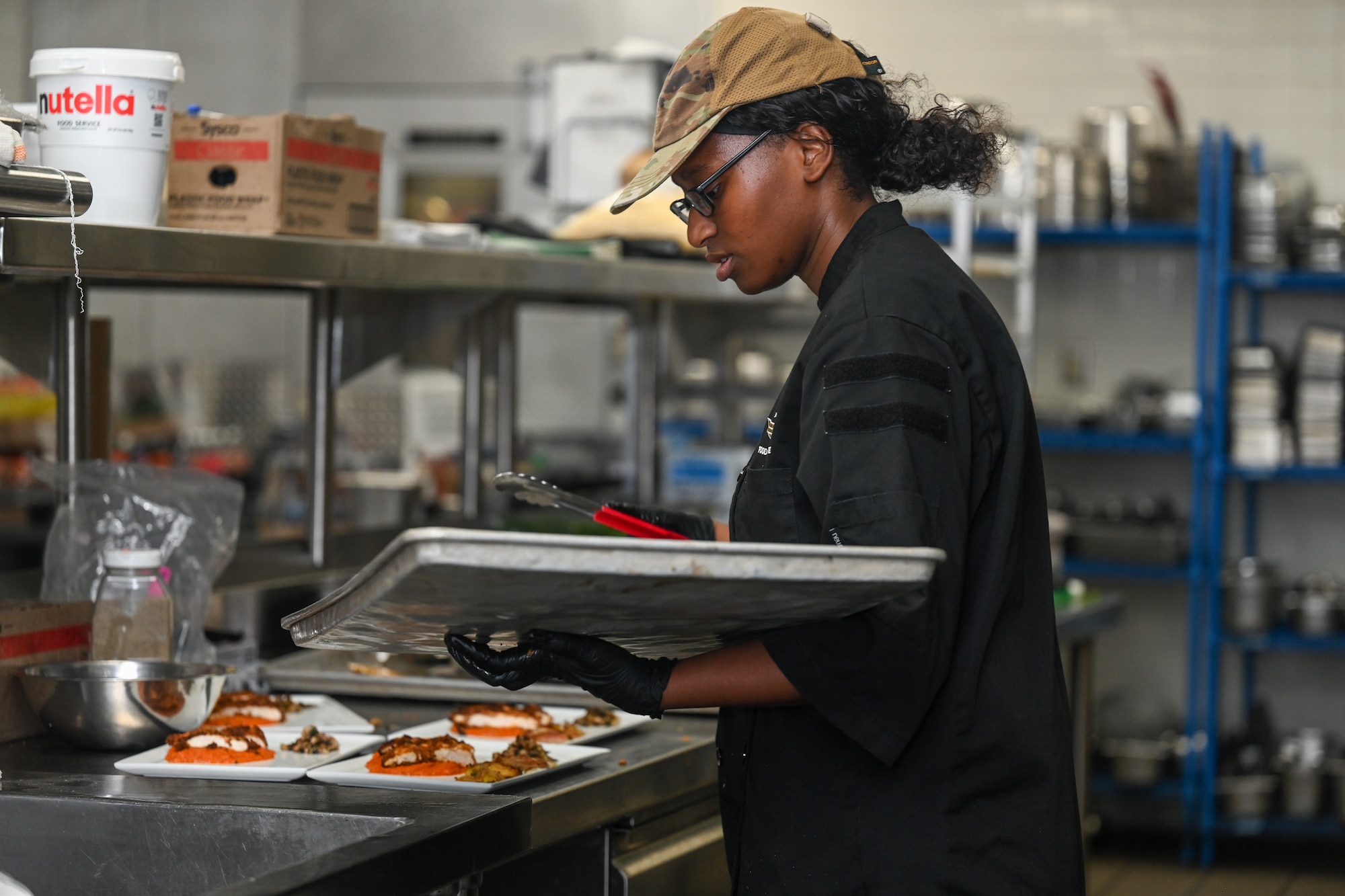 A woman plates her food.