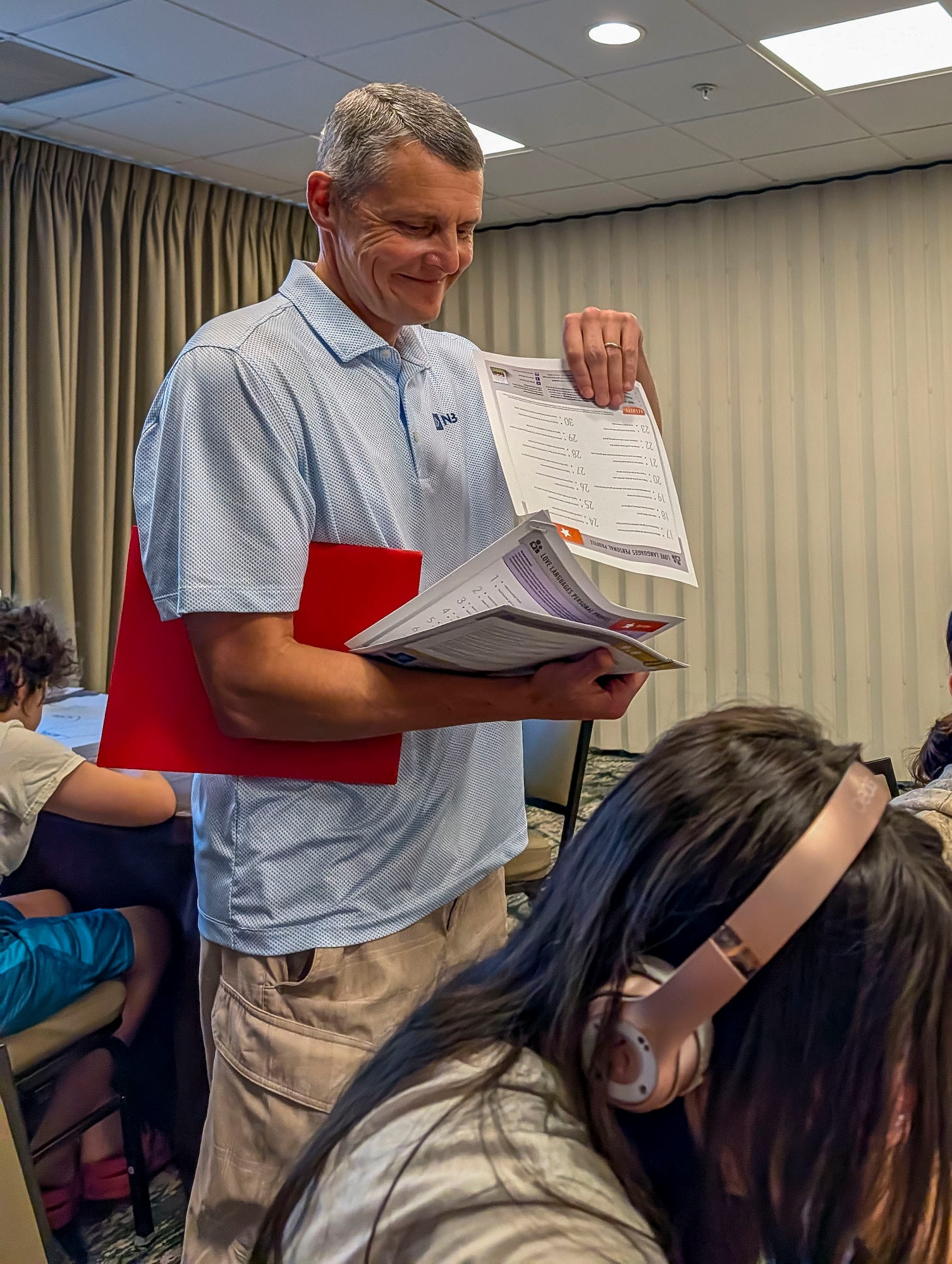 U.S. Air Force Chaplain (Lt. Col.) Clay Carroll, I.G. Brown Training and Education Center, McGhee Tyson Air National Guard Base, Tennessee, reviews handouts during a Strong Bonds retreat, Aug. 16, 2026, in Gatlinburg, Tennessee. This marked the first time TEC hosted an Air National Guard Strong Bonds Resiliency Retreat, which focuses on relationship skills that Airmen and their families can use to communicate effectively, manage challenges and support one another. (Courtesy photo by Master Sgt. Michael Scott)