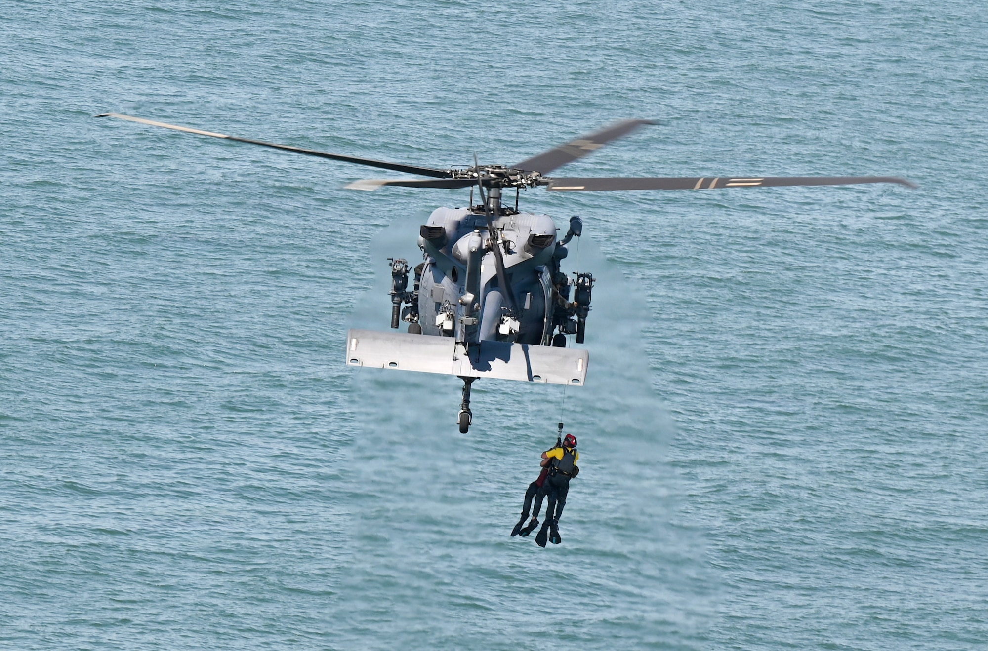 U.S. Air Force pararescuemen assigned to the New York Air National Guard 106th Rescue Wing, are hoisted into an HH-60W Jolly Green II search and rescue helicopter as part of a day-water rescue demonstration during the FourLeaf Air Show at Jones Beach, Wantagh, New York, July 3, 2026. The 106th opened the air show with its annual combat search and rescue demonstration, showcasing the integration of one HC-130J Combat King II aircraft, two HH-60W Jolly Green II helicopters and Guardian Angel personnel, consisting of pararescuemen and combat rescue officers, in a simulated personnel recovery mission. (U.S. Air National Guard photo by Staff Sgt. Sarah McKernan)