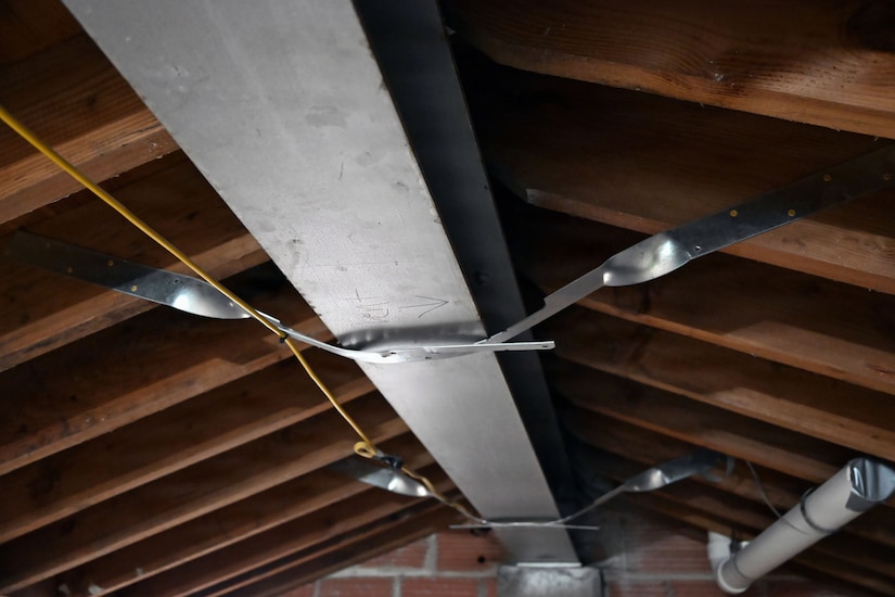 The ceiling roof trusses of a building under construction.