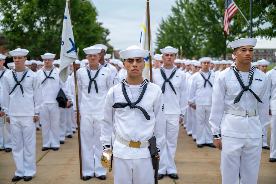 Sailors wait to march into Midway Ceremonial Drill Hall during pass-in-review onboard U.S. Navy Recruit Training Command in Great Lakes, Aug. 6, 2026. Training is approximately nine weeks and all enlistees in the U.S. Navy begin their career at the command. More than 40,000 recruits train annually at the Navy’s only boot camp.